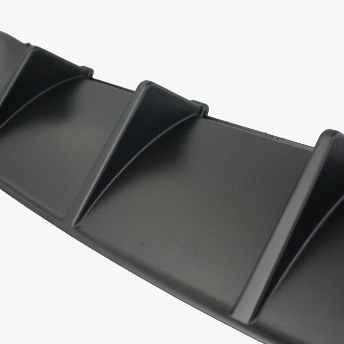 Rear bumper diffuser insert, dark gray with raised slat details and ridged edges