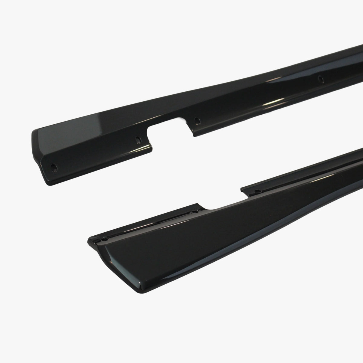 Black side skirt extension close-up with mounting holes and integrated end caps