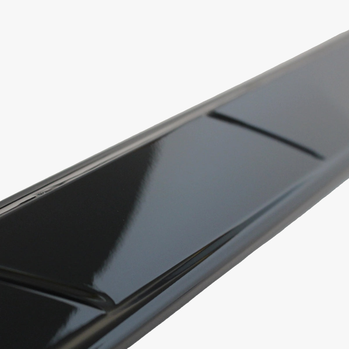Close-up of black glossy side skirt extension panel edge and channel