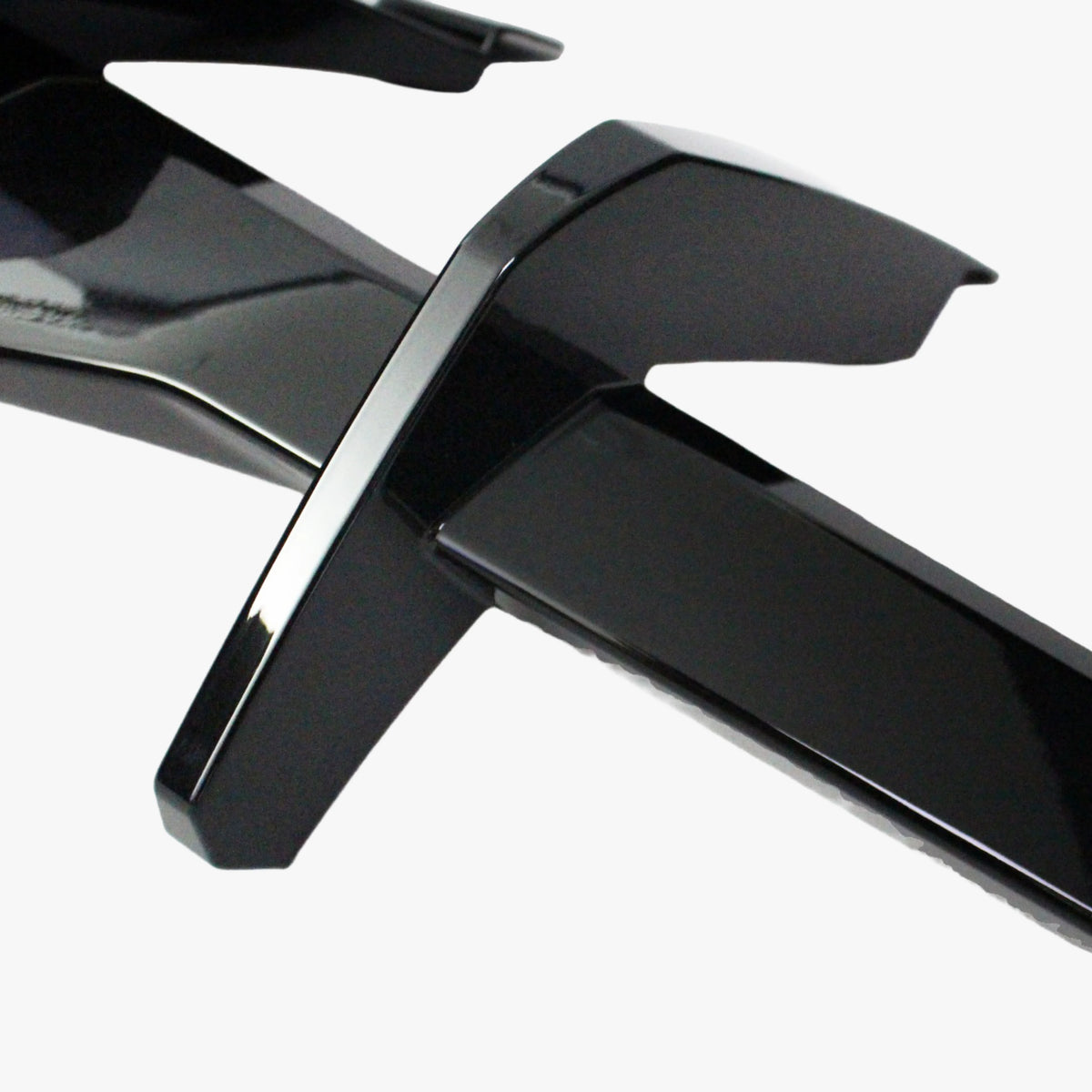 Matte black diffuser lip close-up with cross fin bracket and edge detail